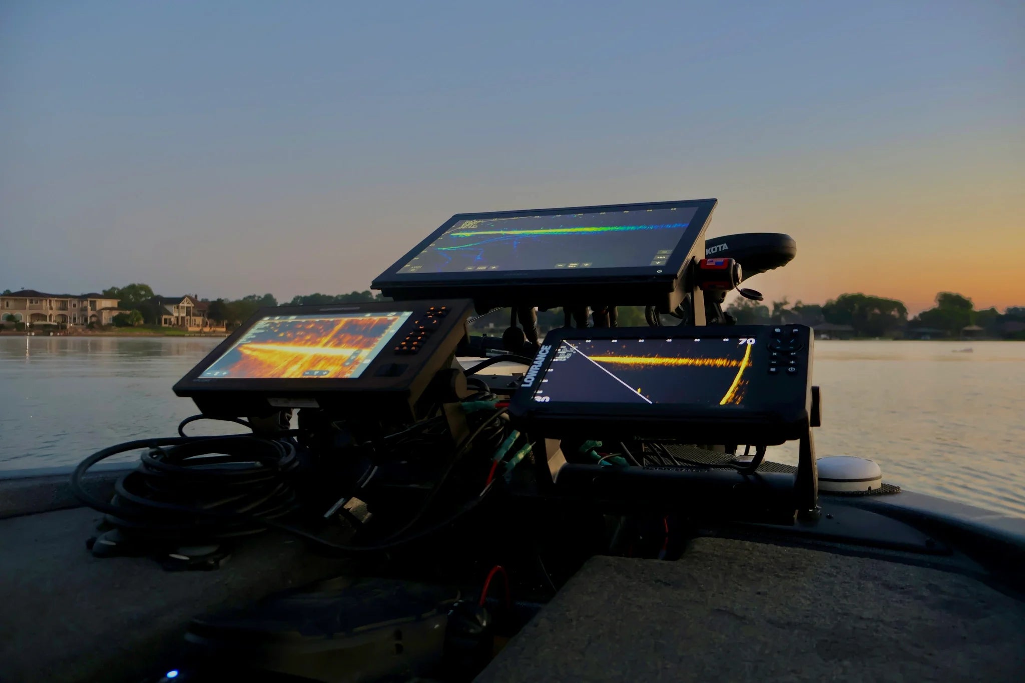 White text saying "Fishfinder Coach Bundles, save 15-20% on your setup" on top of a triple fishfinder setup the bow of a boat. 