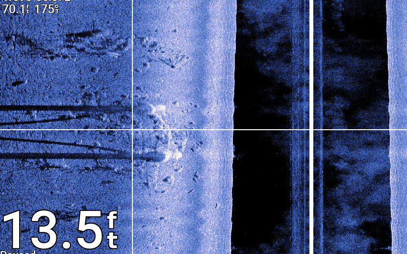 "Sonar image showing underwater terrain at 13.5 feet depth with blue hues and grid overlay"