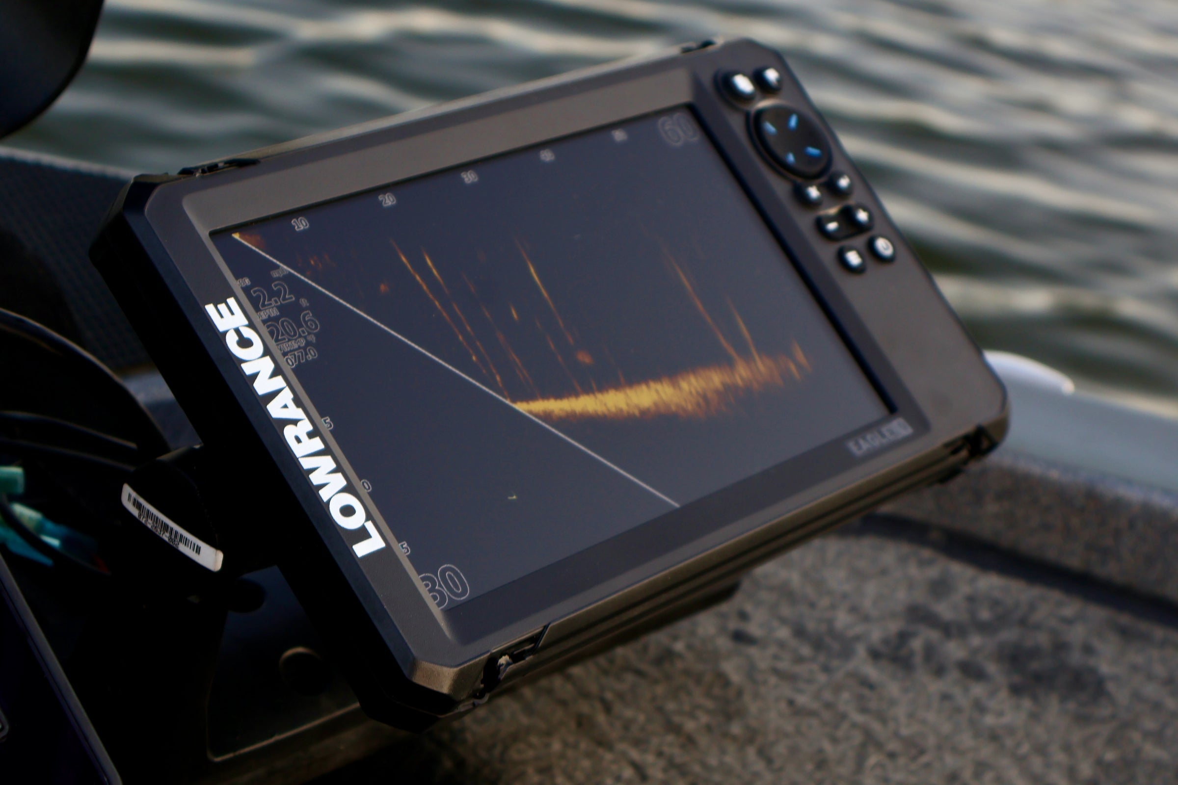 Fishing sonar device on a boat with water in the background