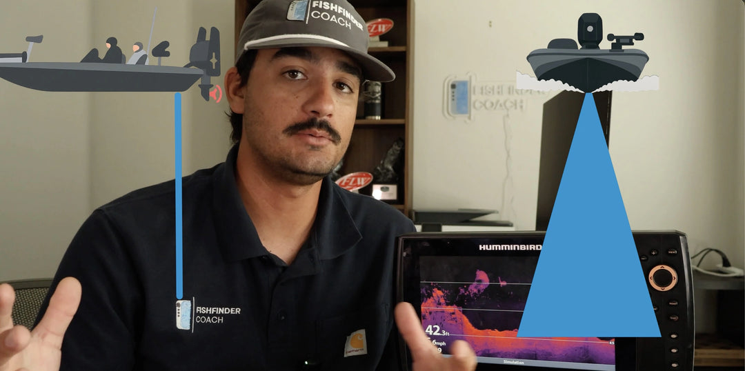 Person in a black shirt with a cap, standing in an office setting with computer monitors and shelves.