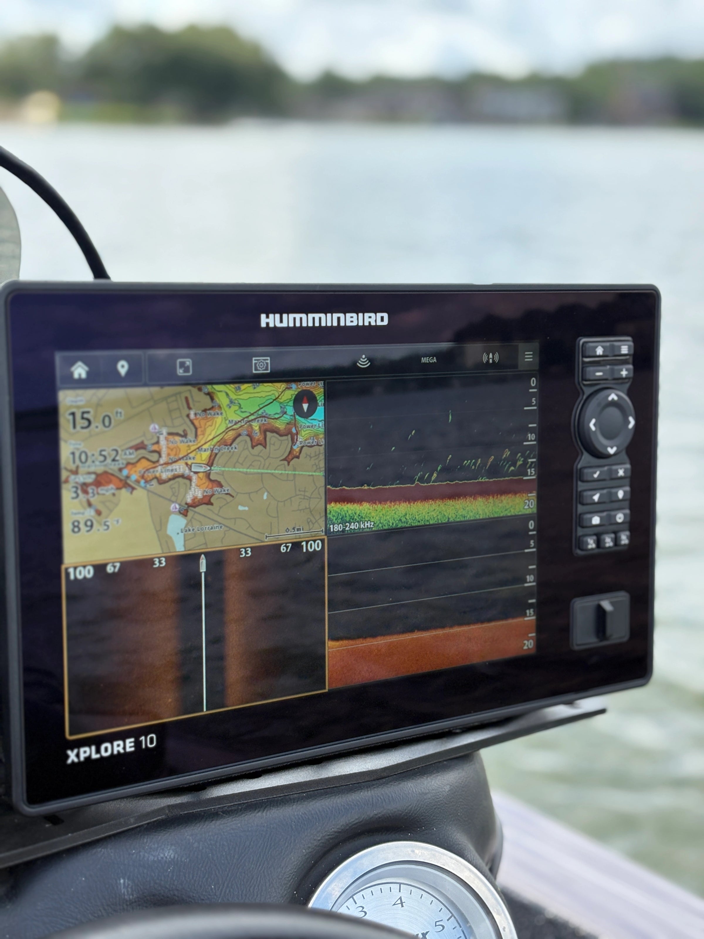 Humminbird Xplore 10 marine navigation display on a boat with water in the background