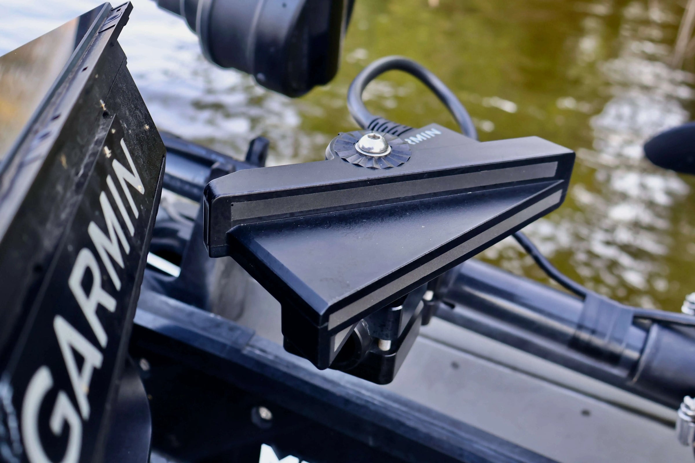 Garmin fishfinder mounted on a boat with water in the background