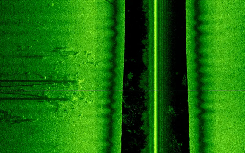 Close-up of a green textured surface with a dark vertical line.