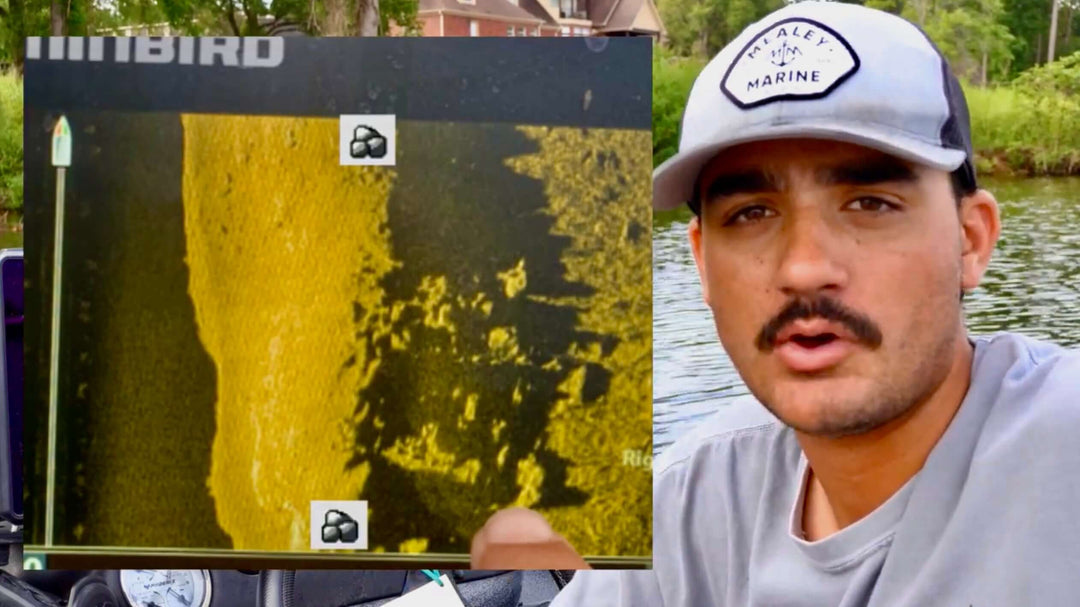 "Person demonstrating fish finder technology on a lake boat trip"